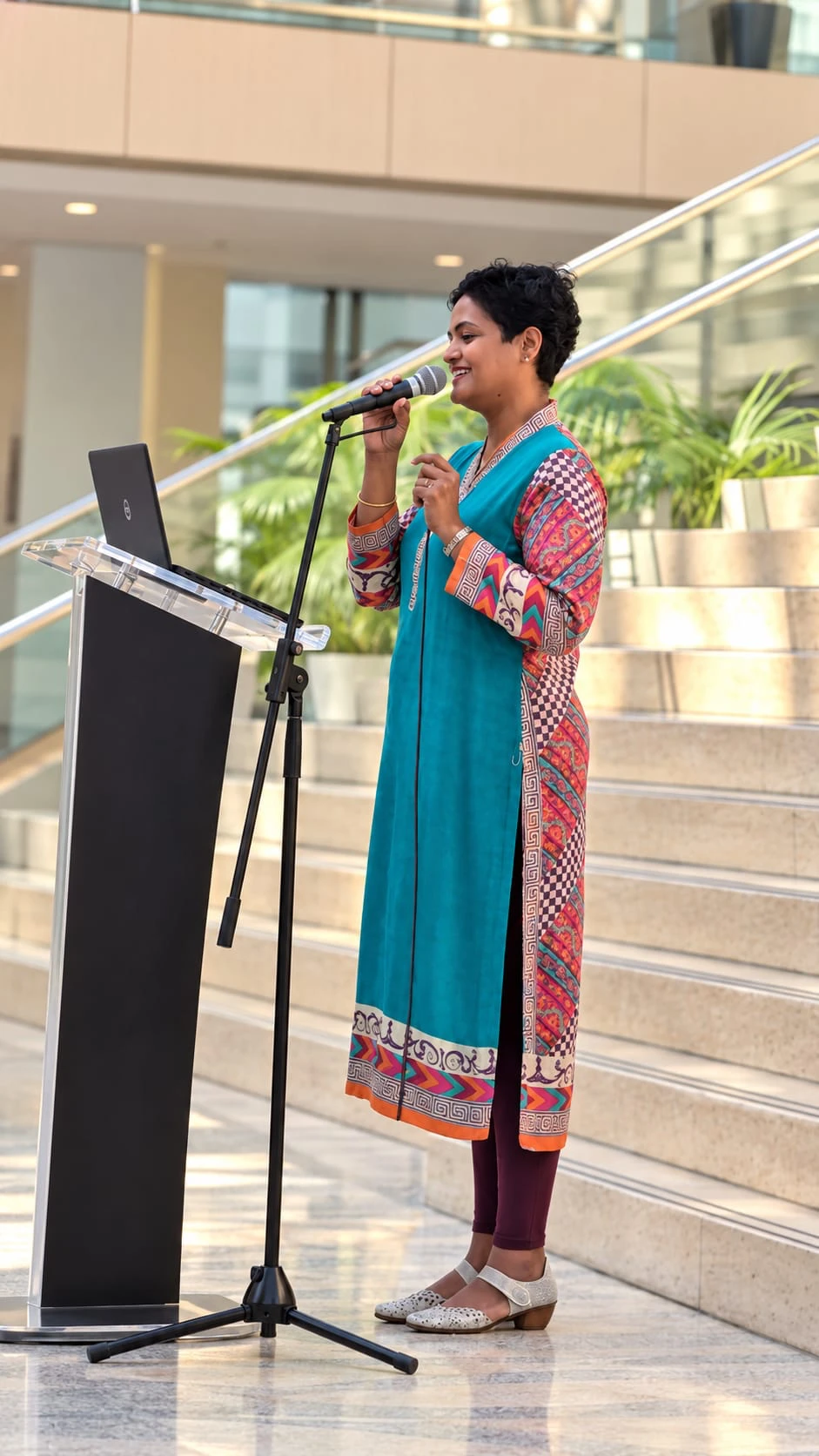 Mary Thomas speaking at a podium