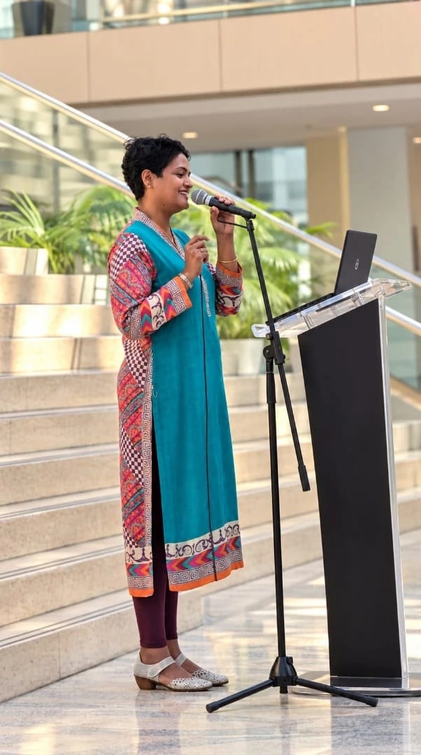 Mary Thomas speaking at a podium